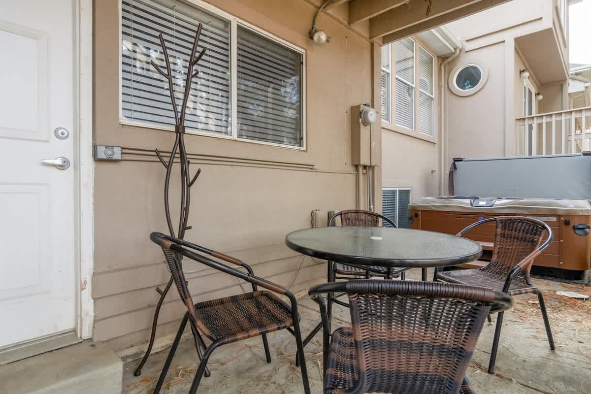 Small back patio with dining set and private hot tub