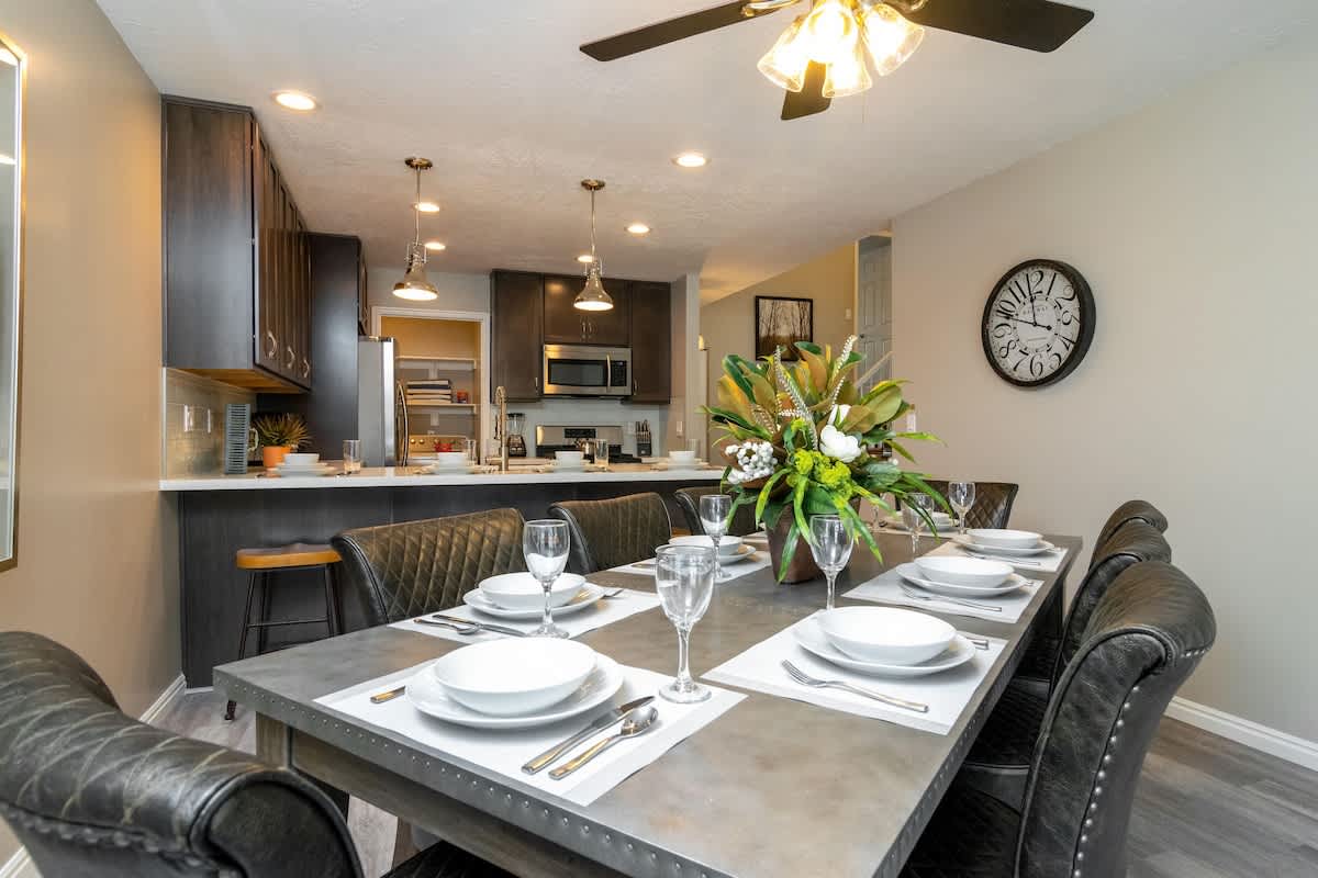 Open concept layout with dining table for 6 and bar for 4