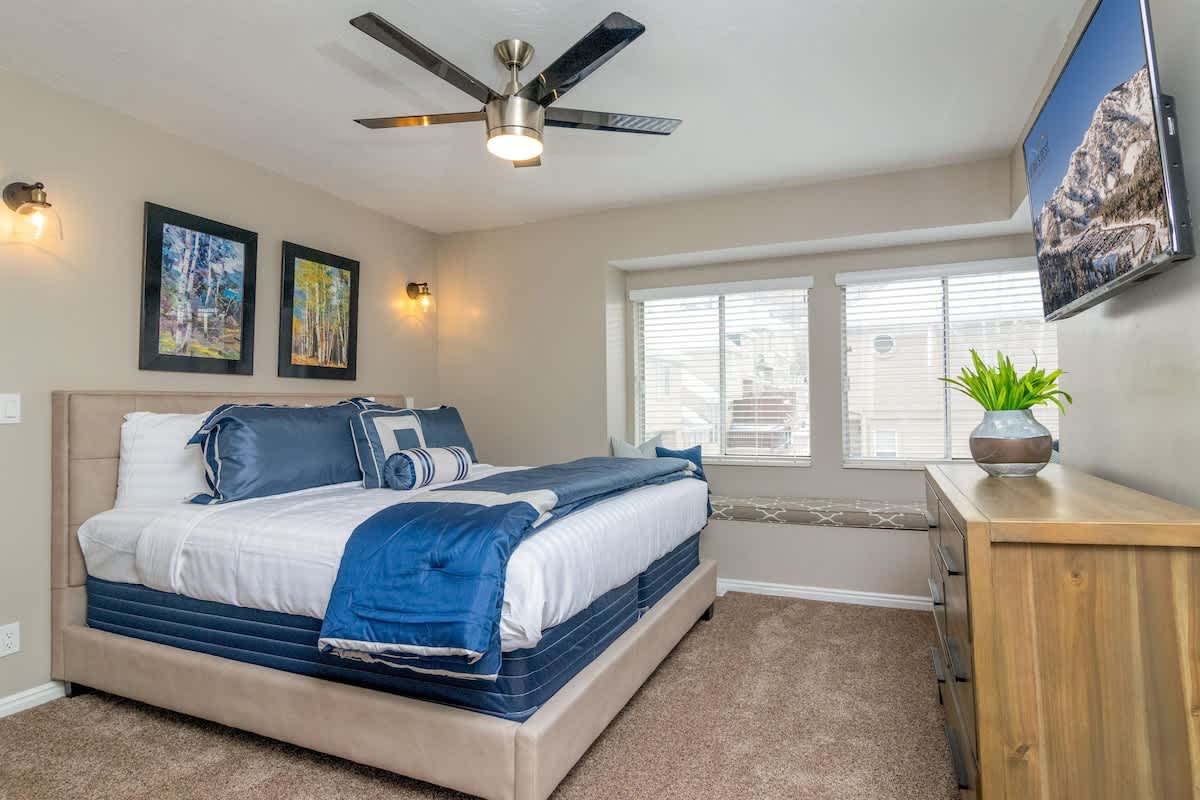 Master bedroom with king bed and TV