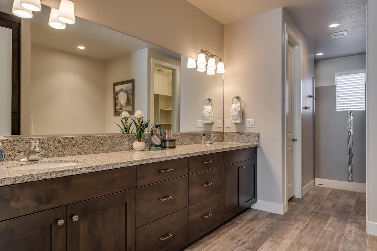 Bathroom for bedroom 1 - Double sink vanity, garden tub, and a walk-in shower