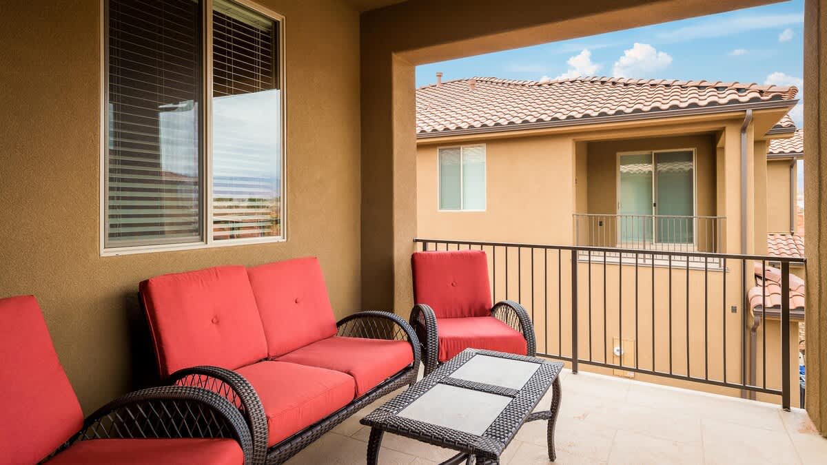 Covered balcony off the upstairs family room with comfy seating