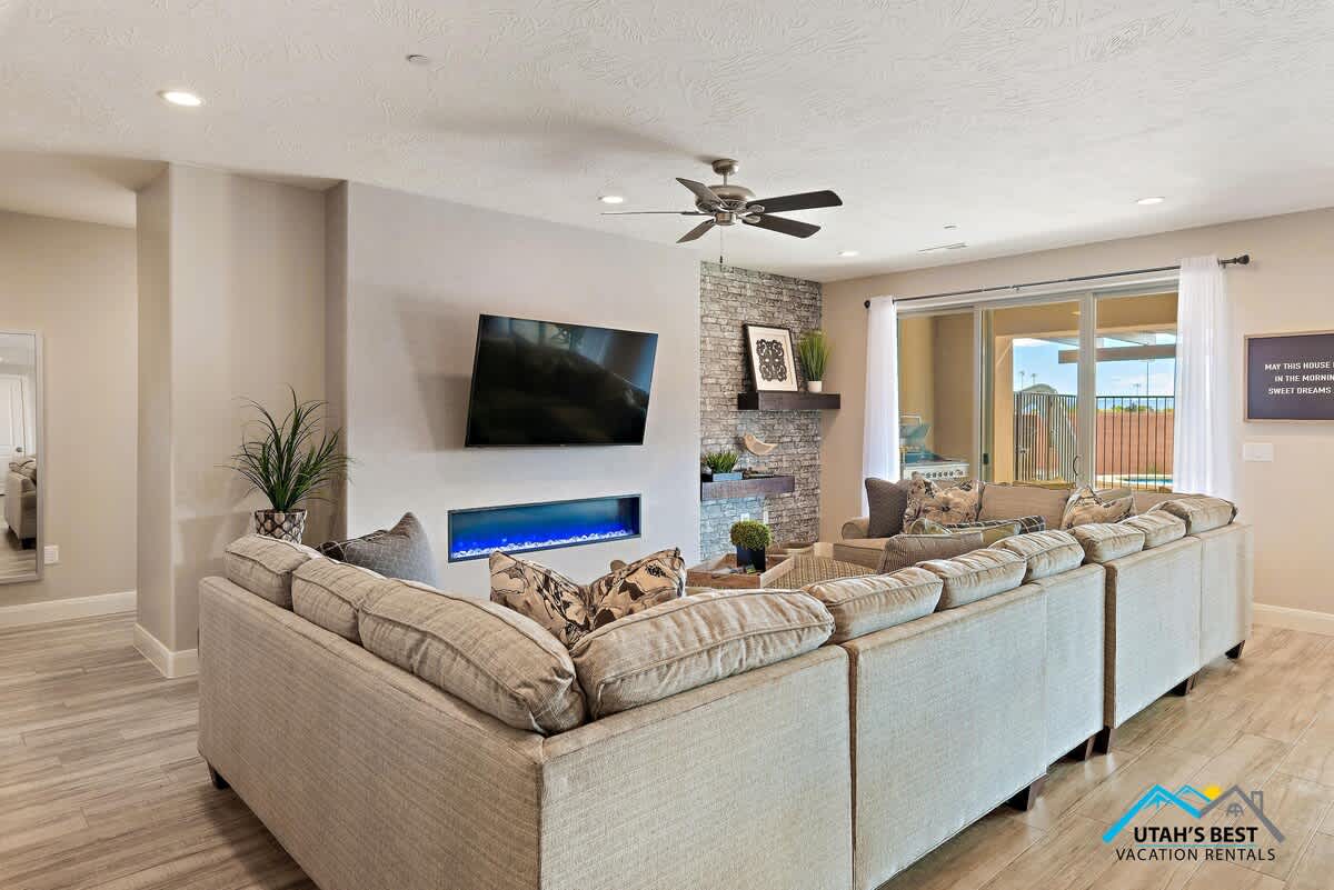 Open living room off the kitchen with comfortable seating, a fireplace, and TV