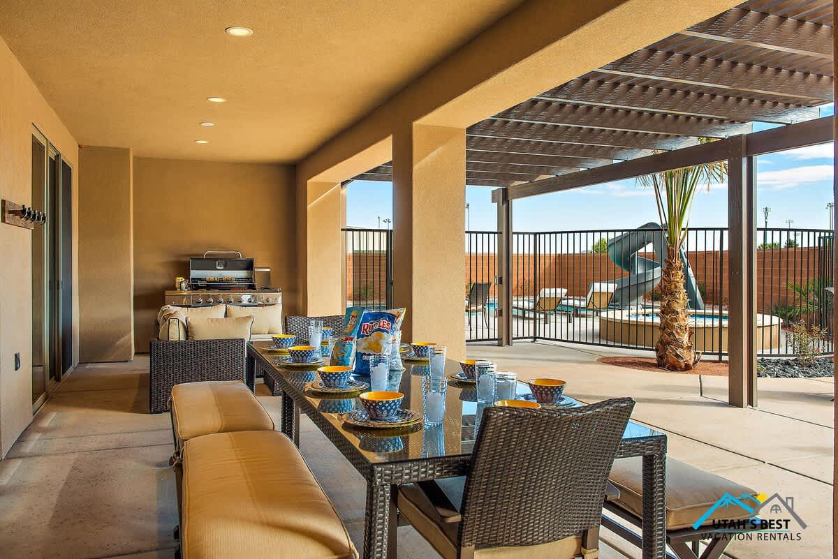 Spacious covered patio off the living room with outdoor dining space and a gas BBQ