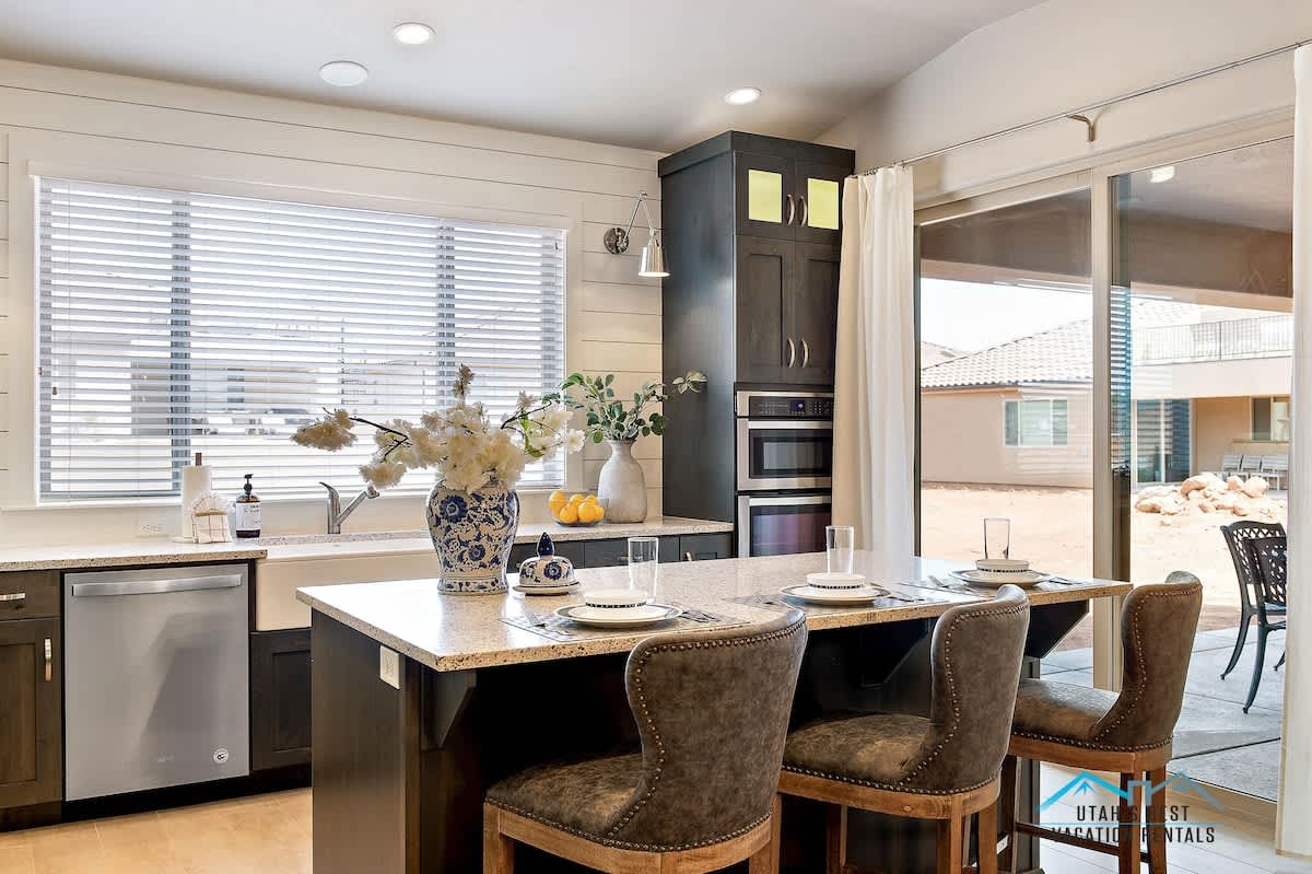 Island bar seats 3 and poolside patio access for more seating