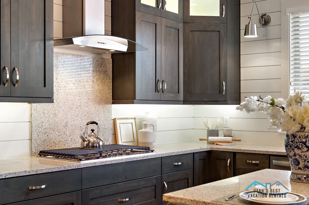 Kitchen with gorgeous cabinetry, stonework, gas cooktop