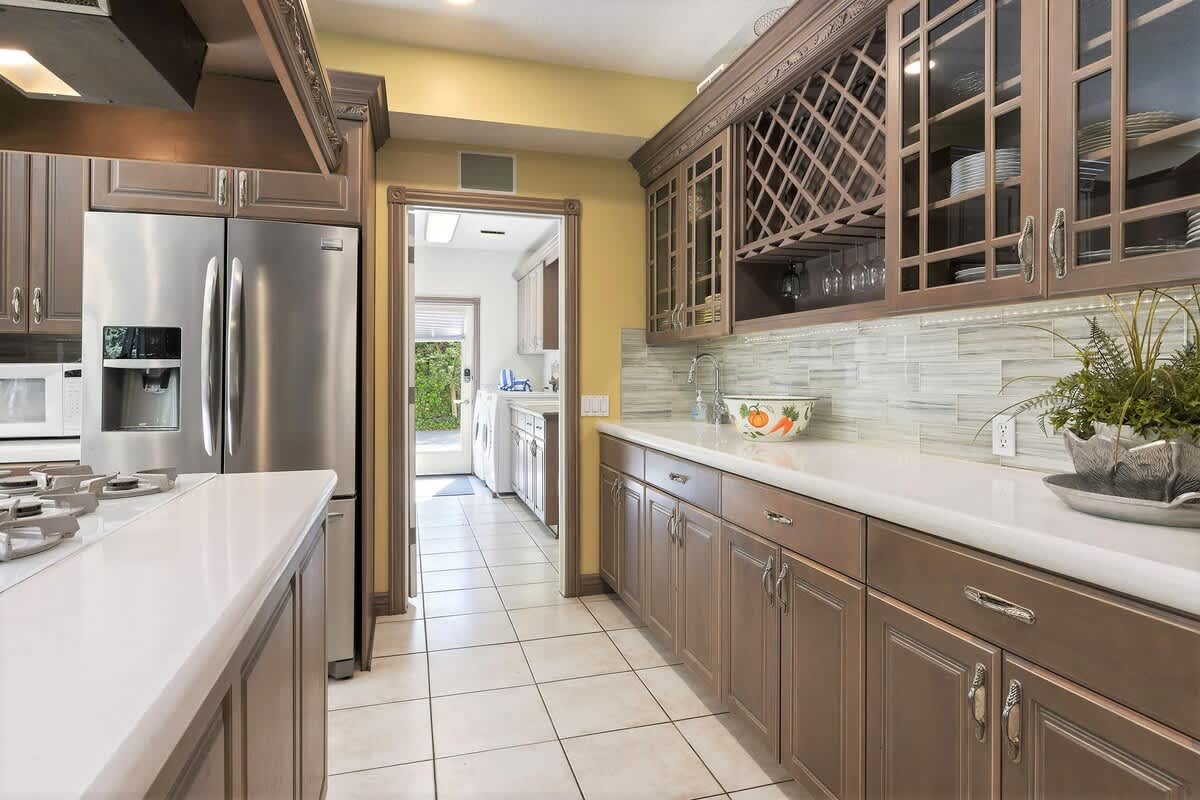Kitchen buffet with glass tile backsplash and mudroom access