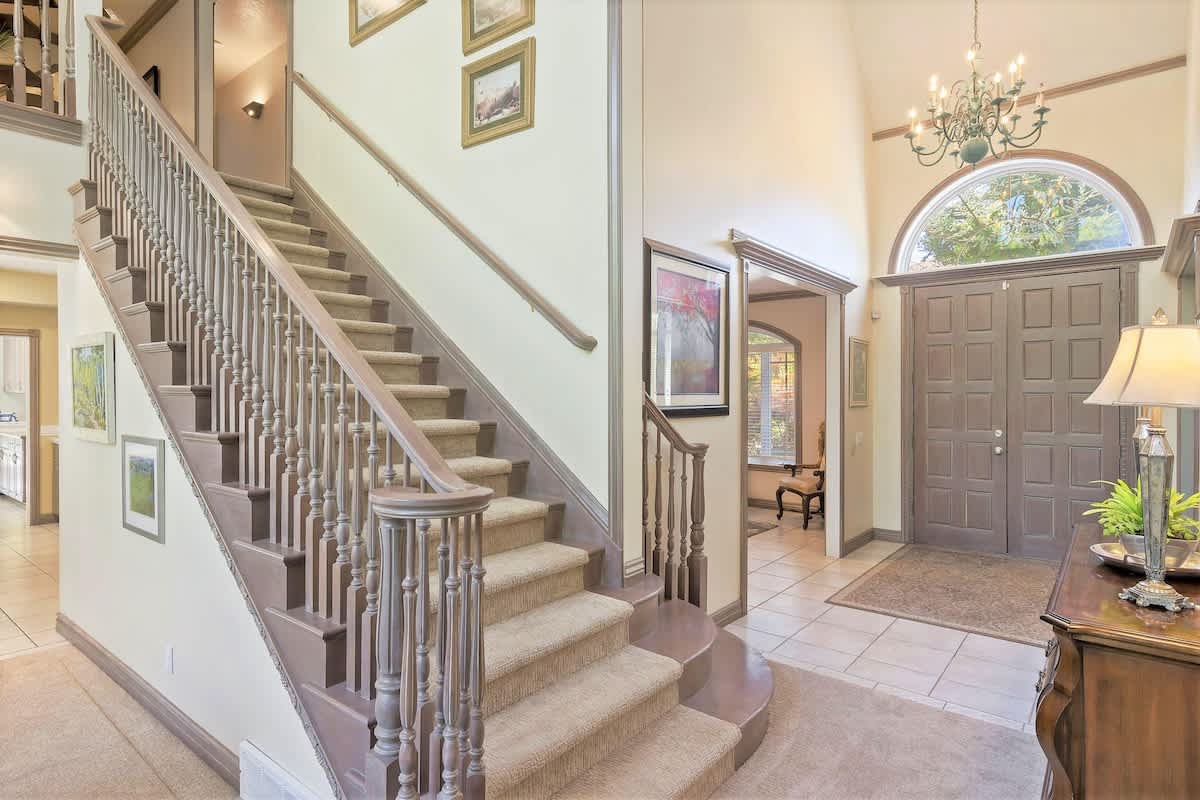Stunning grand entrance with expansive ceilings and woodwork
