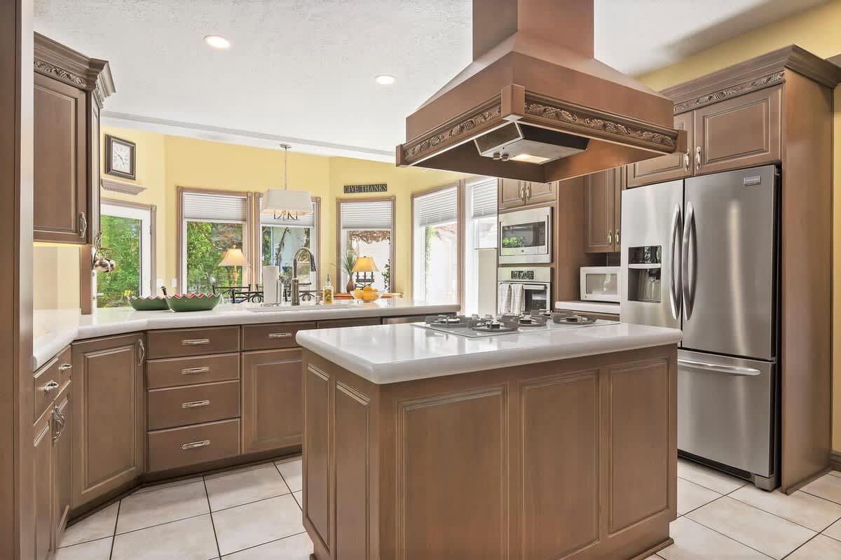Kitchen island with gas cooktop and stainless steel appliances
