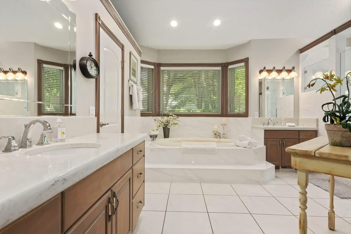 Master bathroom with his and her vanities, jetted tub and shower