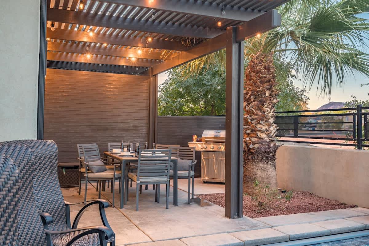 Pergola-covered patio dining area seats 6 and BBQ provided