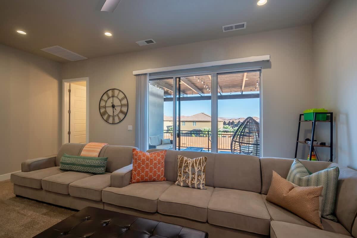 Family room with sliding doors to balcony overlooking pool