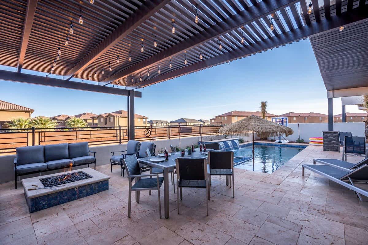 Oasis backyard with pergola-covered dining area, pool and fire p