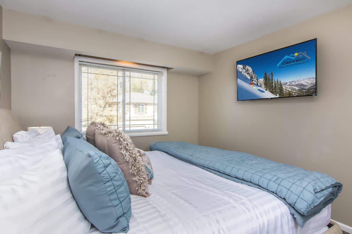 Bedroom 2 with queen bed and TV