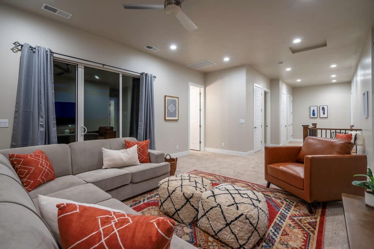 Family room 2 with large sectional sofa and balcony access