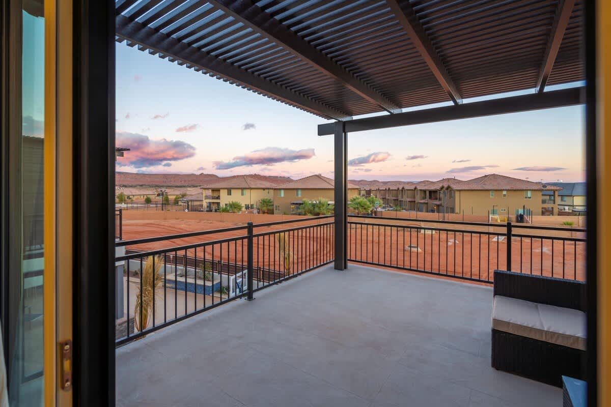 Pergola-covered upper balcony with pool view