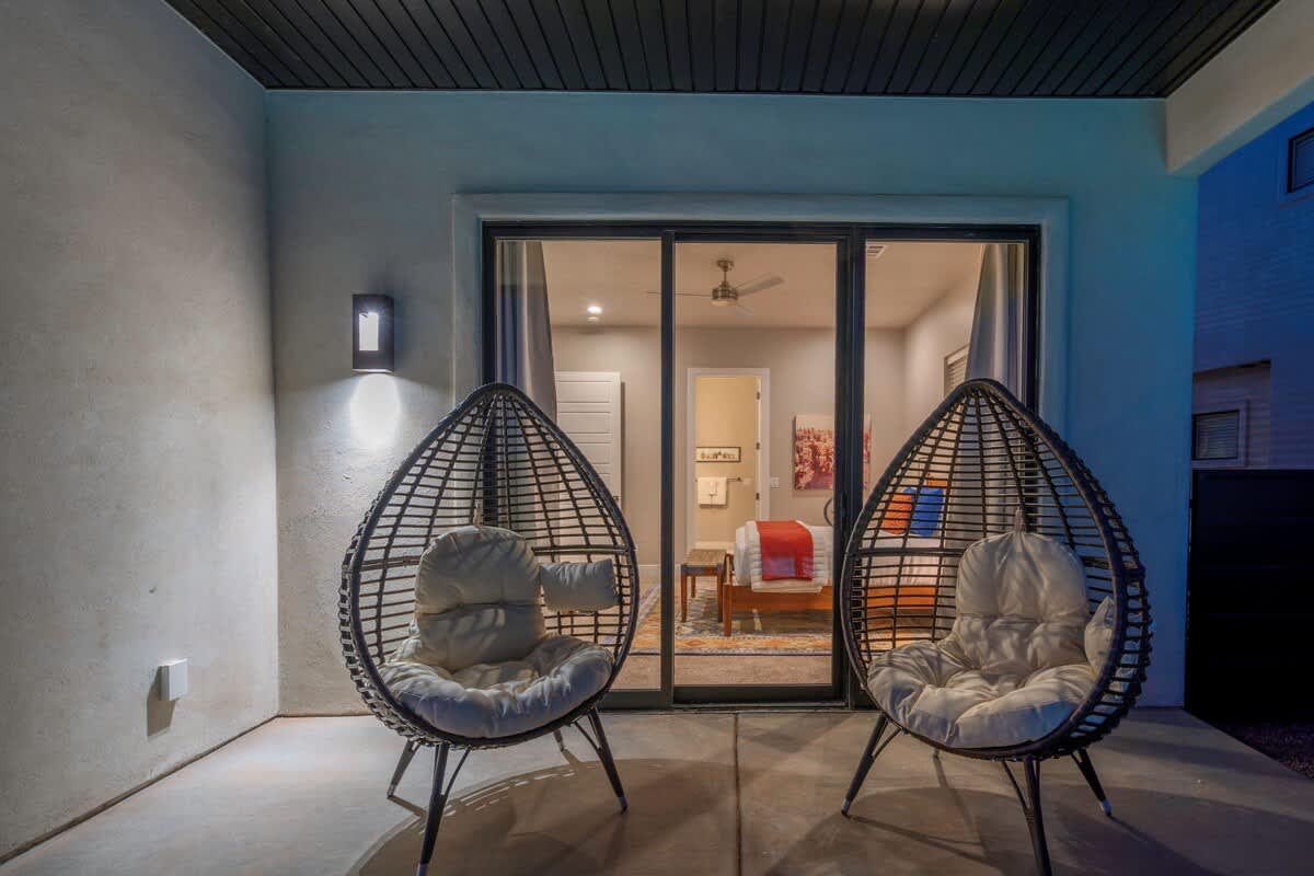 Private poolside patio off master suite with 2 custom chairs