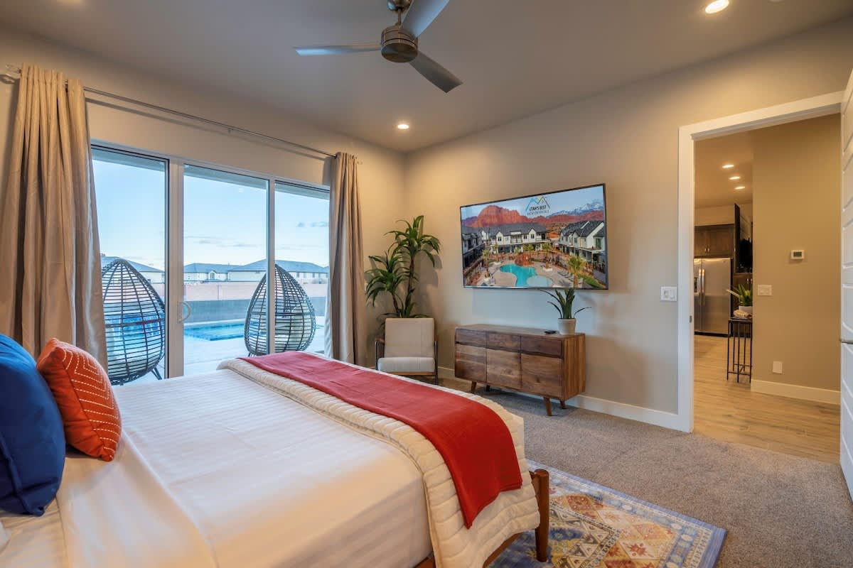Master bedroom on main with king bed and poolside patio