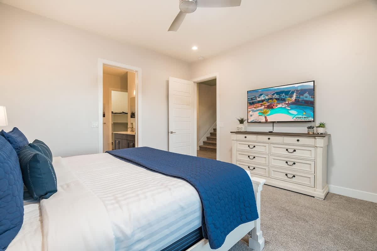Master bedroom on main level with king bed and TV