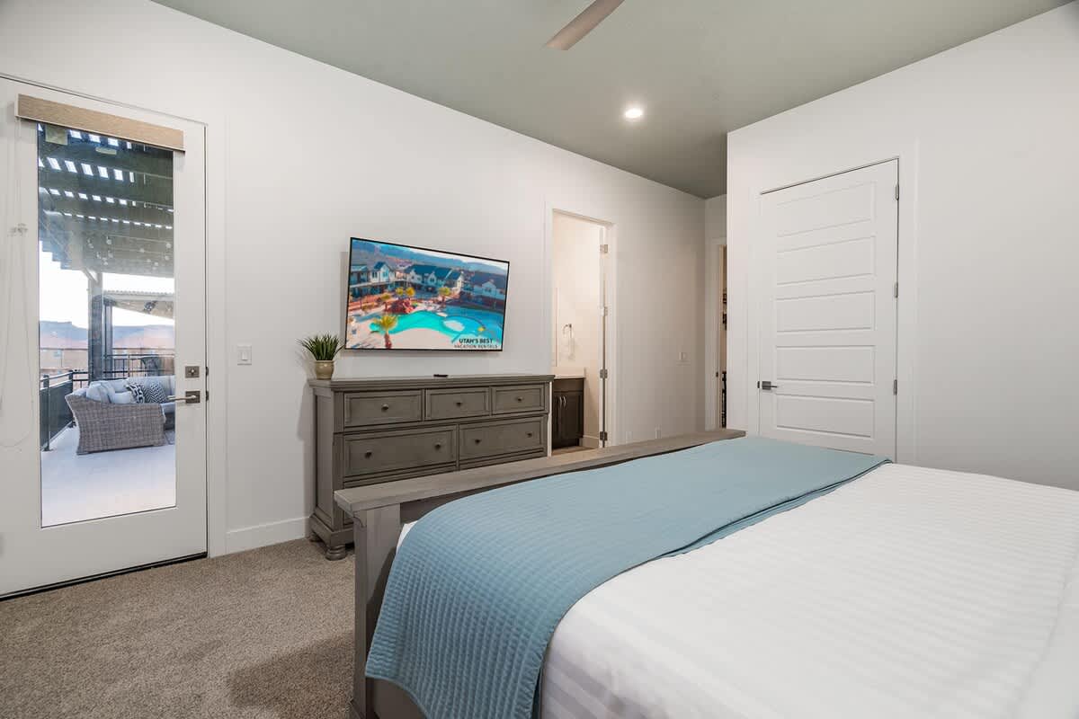 Bedroom 3 with king bed, TV and private balcony with pool view