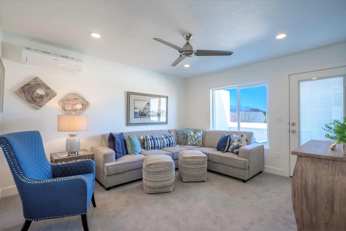 Family room on 3rd level with comfortable sectional and balcony