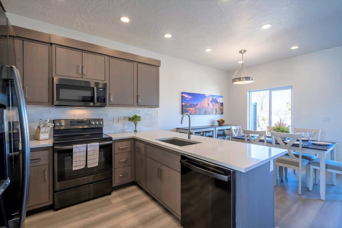 Stylish spacious kitchen with peninsula bar seating and dining