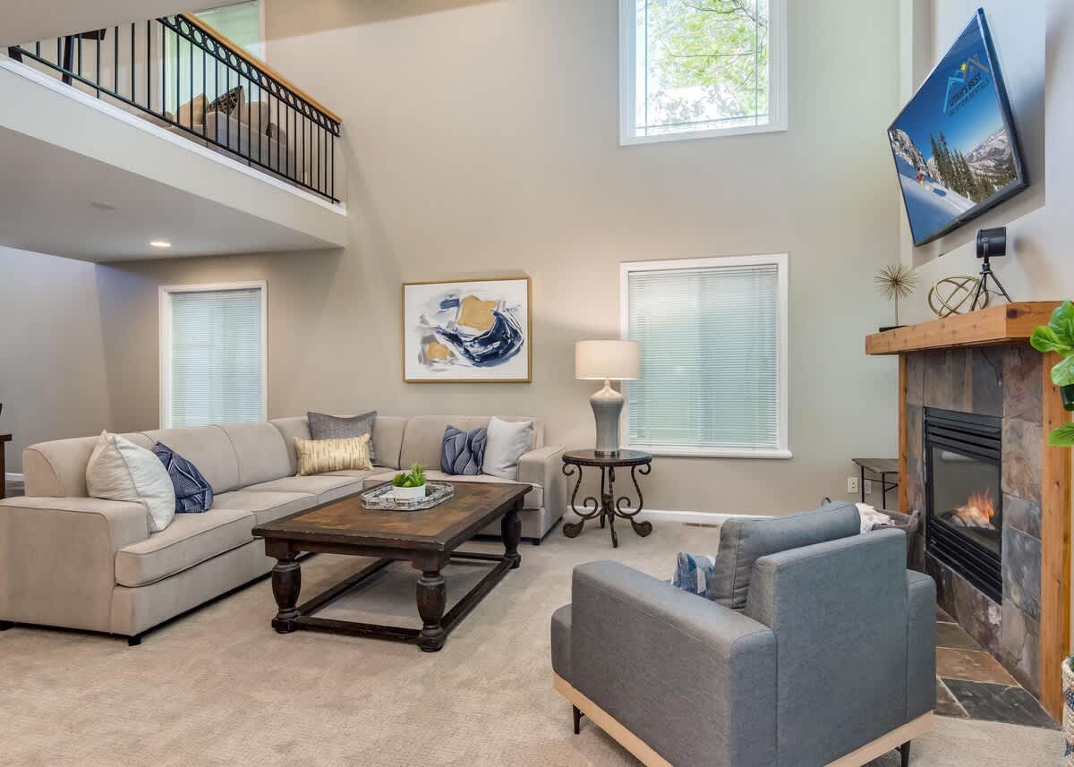 Sectional and fireplace open to upper floor