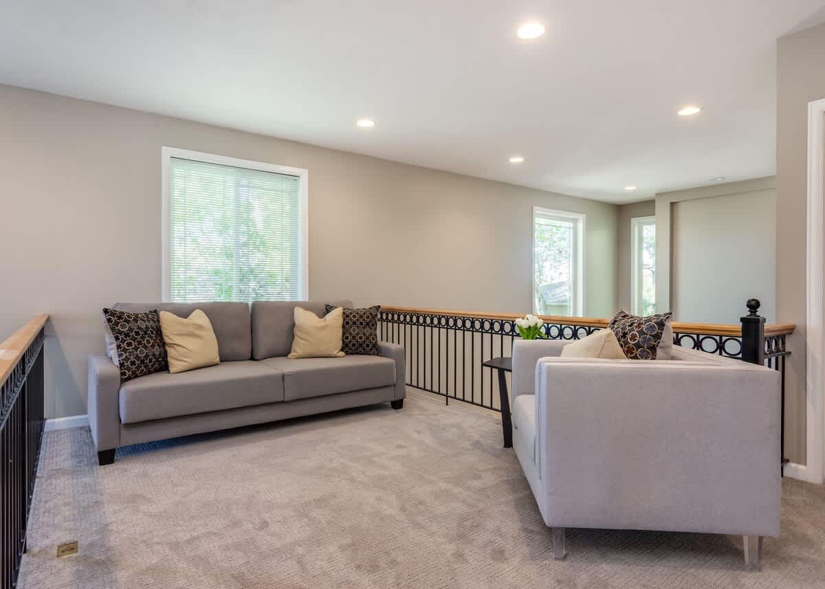 Loft upstairs with sofa seating and chair