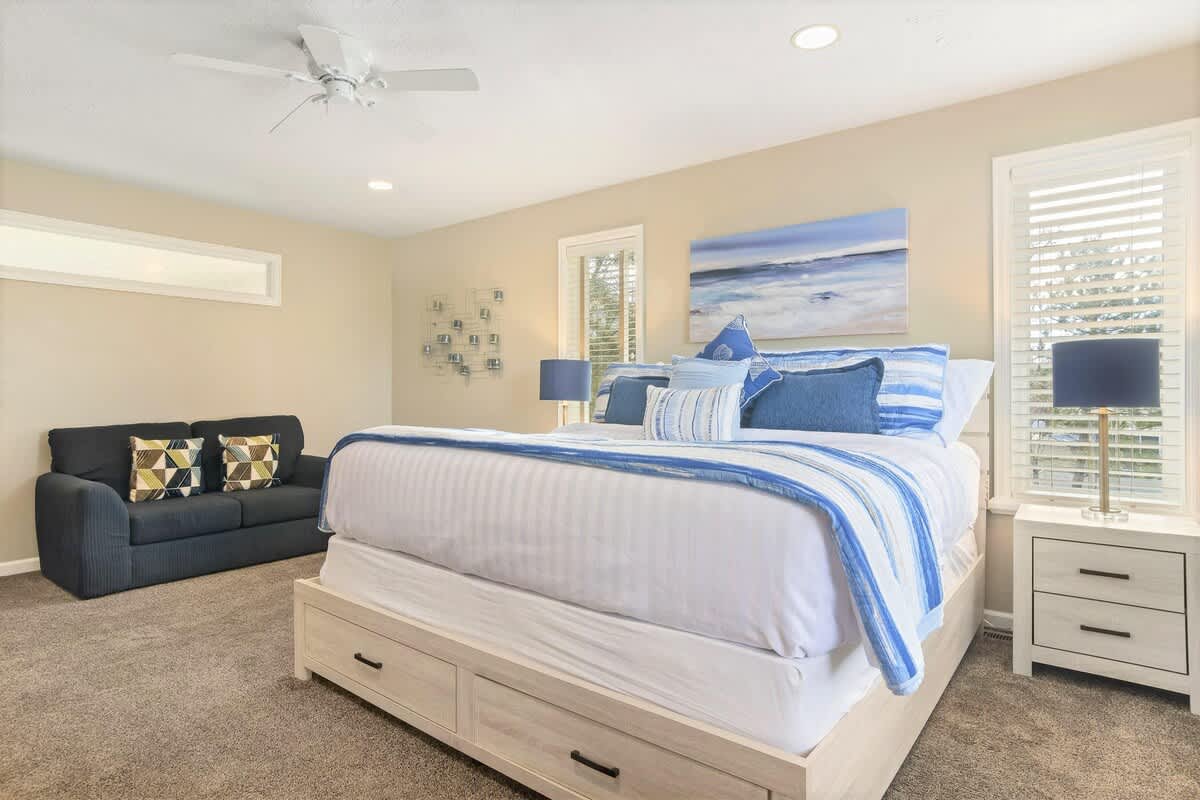 House 1 master bedroom with king bed, TV, dresser