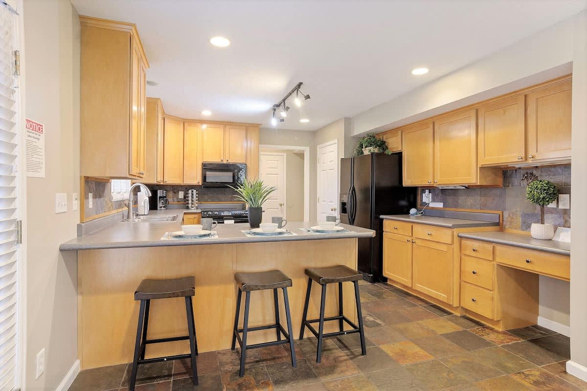 House 1 fully equipped kitchen with bar seating for 3