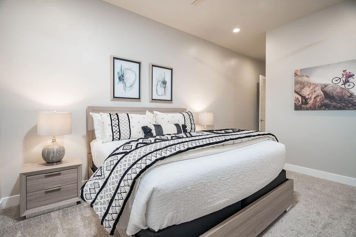 Bedroom 4 with king bed and large 72-inch smart TV