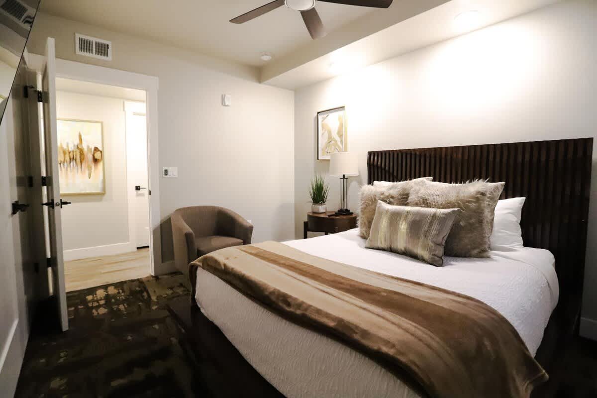Bedroom 2 with a queen bed and chair