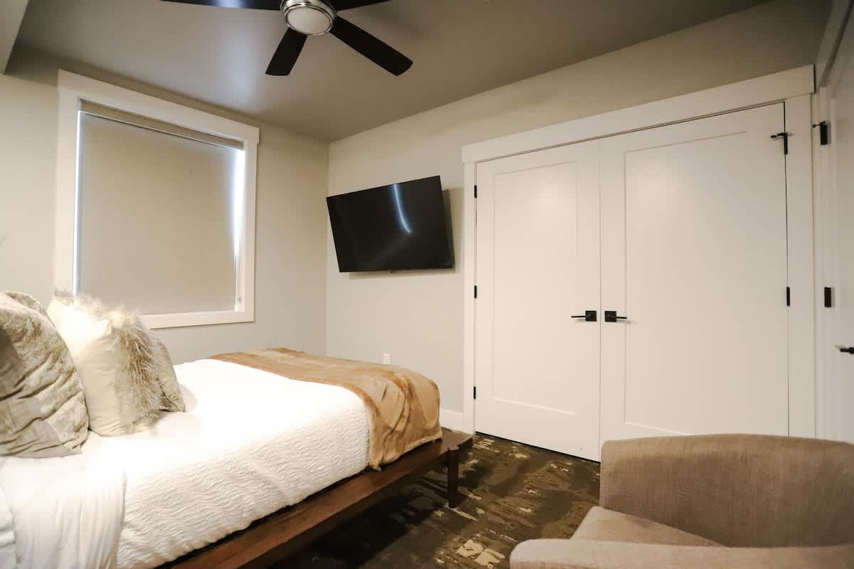 Bedroom 2 with queen bed, TV, and closet