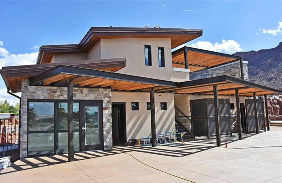 Poolside clubhouse building with upper balcony terrace