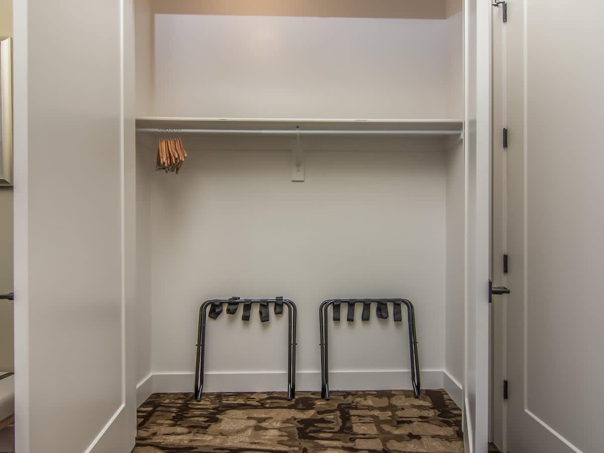 Bedroom 2 closet with 2 luggage holders and hangers provided