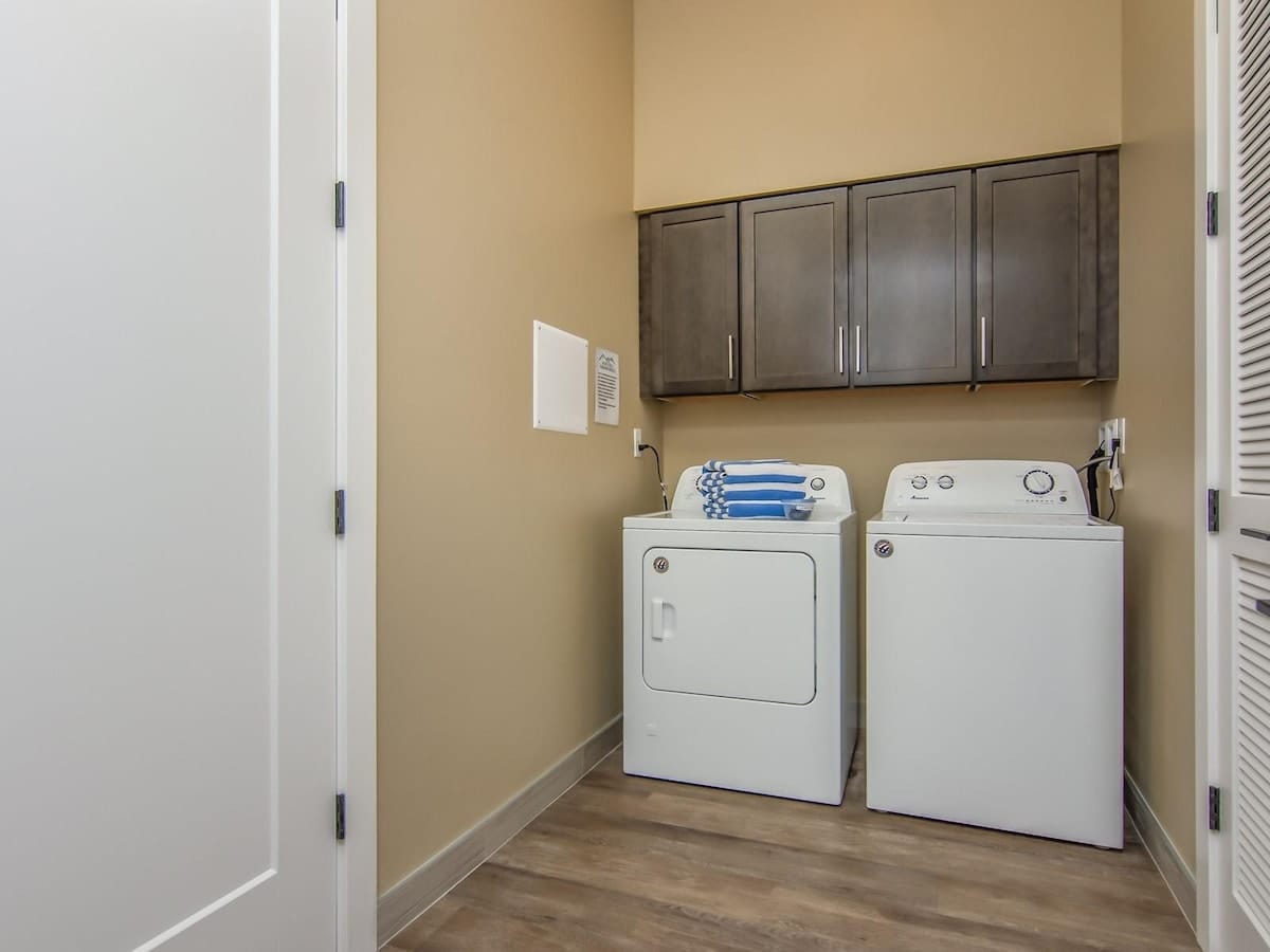 Laundry room with washer and dyer and pool towels provided