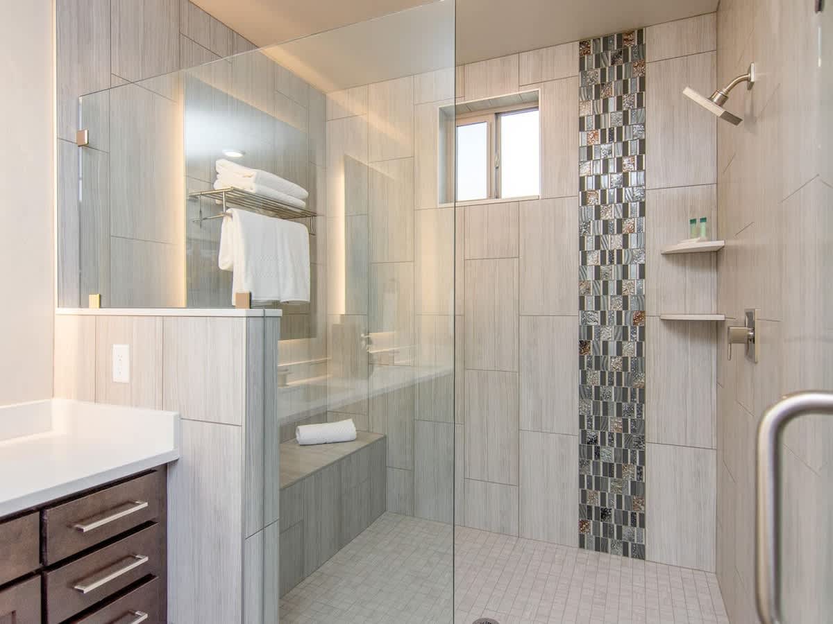Luxury over-sized shower in master bathroom with large bench