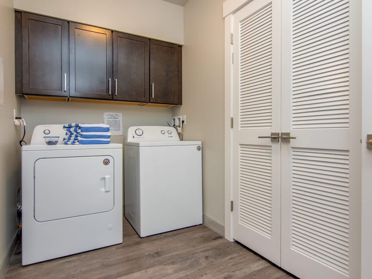 Laundry room with washer and dryer and pool towels provided