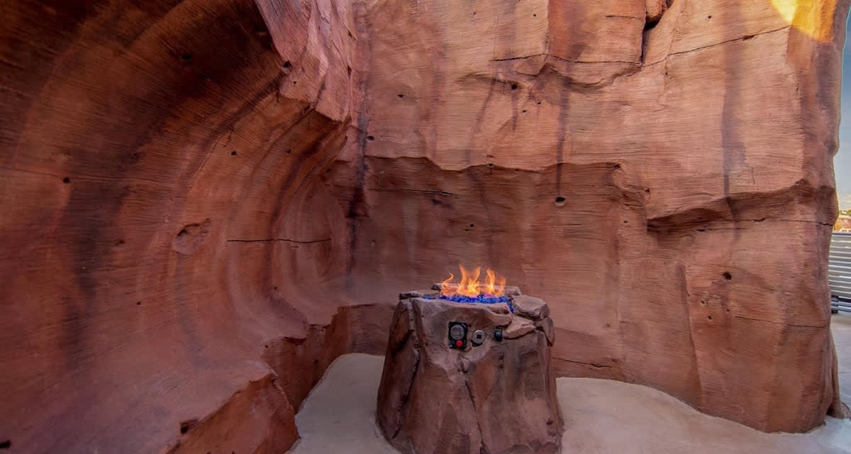 Hidden fire pits in red rock formations poolside