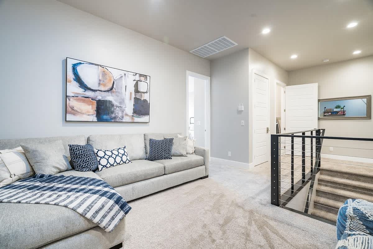 Family room upstairs with comfortable sofas and large TV