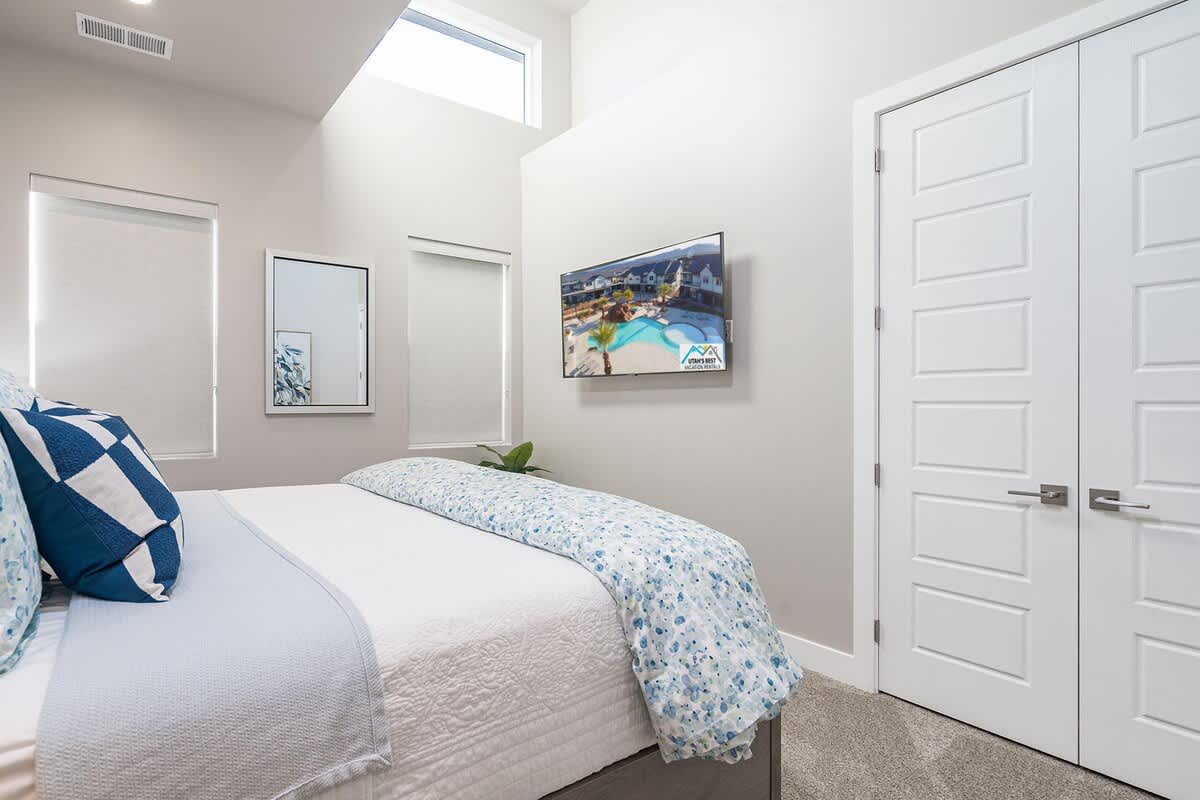 Master suite with king bed, vaulted ceiling and TV