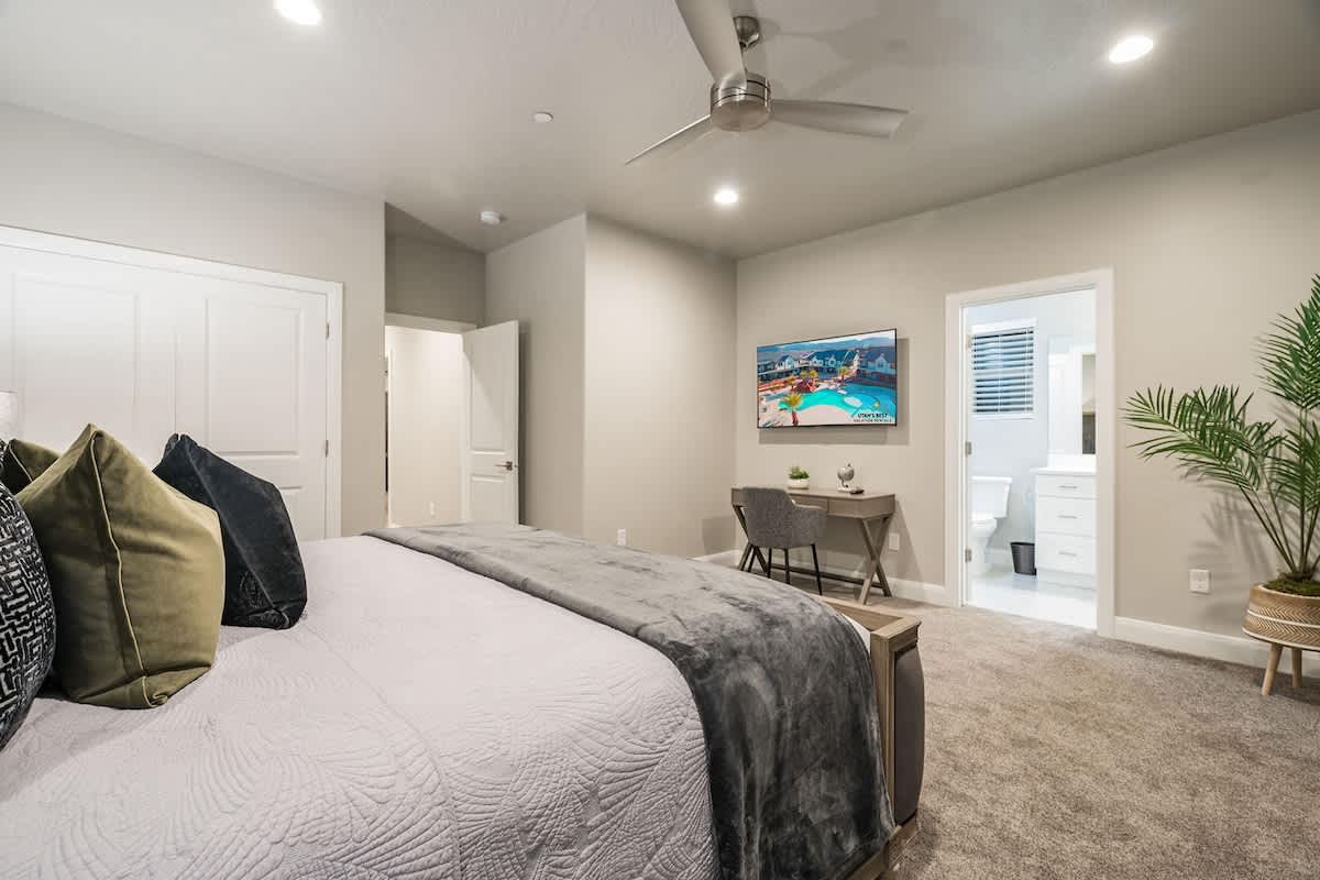 Bedroom 6 with king bed, TV, desk and bathroom