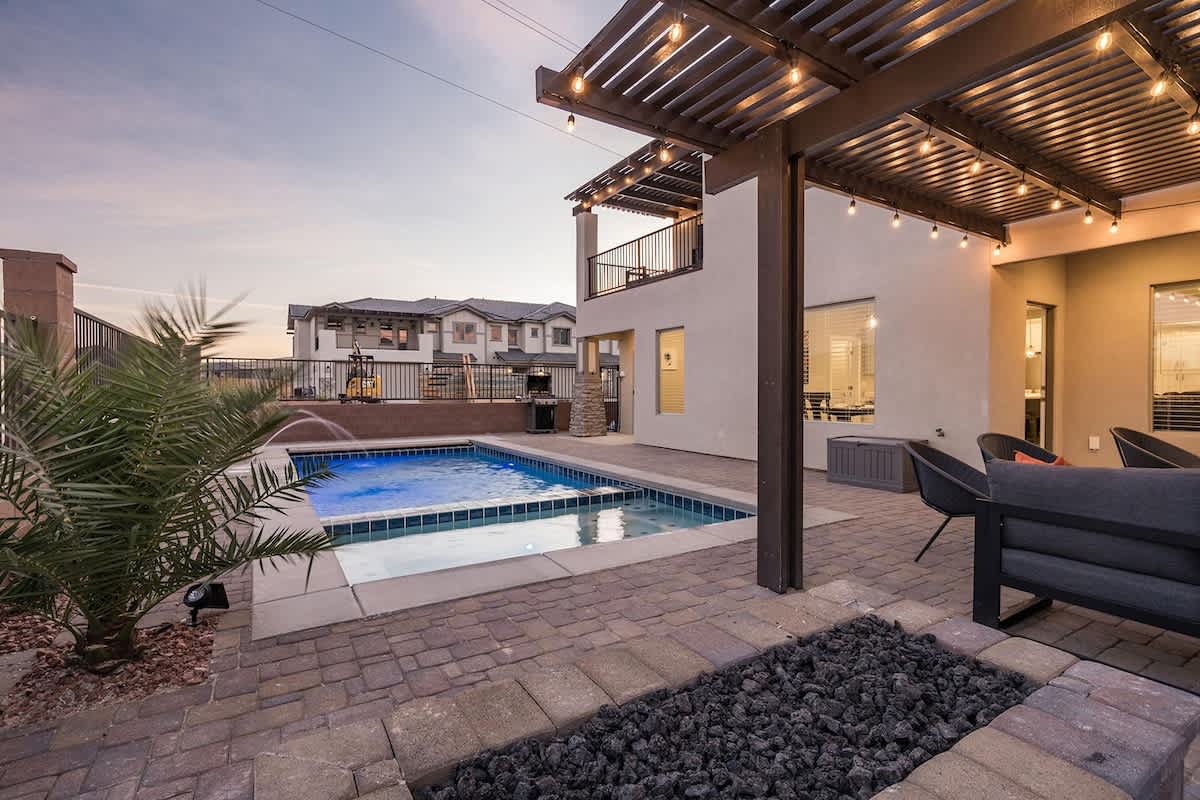 Enjoy pool, hot tub, fire pit and pergola-covered patio seating
