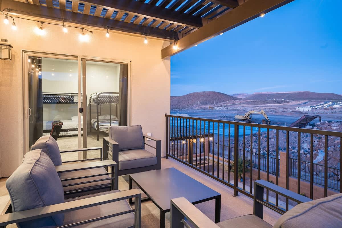 Pergola-covered upper terrace with pool view below