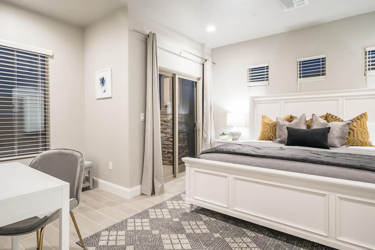 Master bedroom with king bed and access to pool