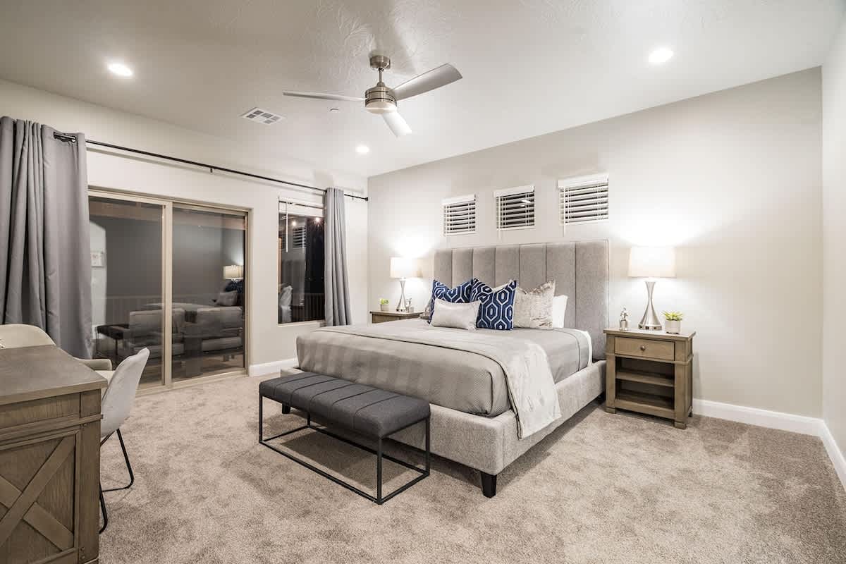 Bedroom 5 with king bed, desk, and balcony access