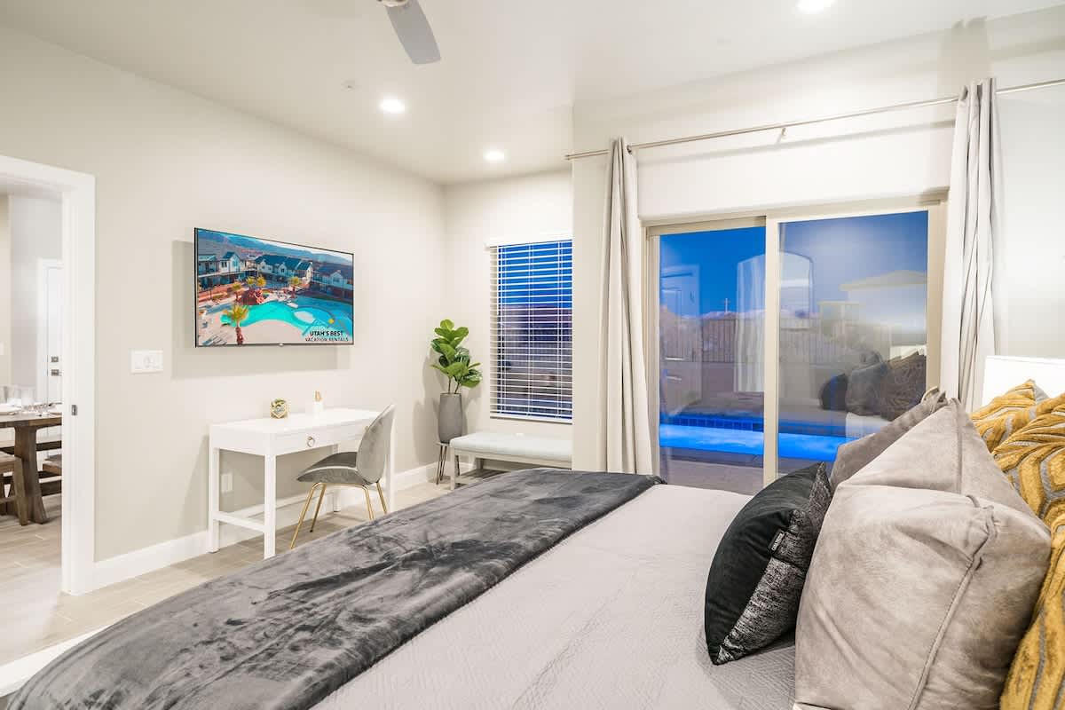 Master bedroom with access to pool and TV with desk