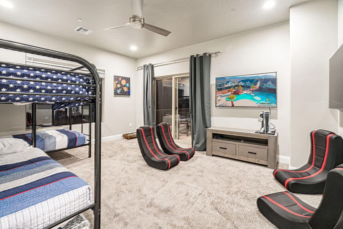 Bedroom and gaming room with 2 bunks and gaming equipment