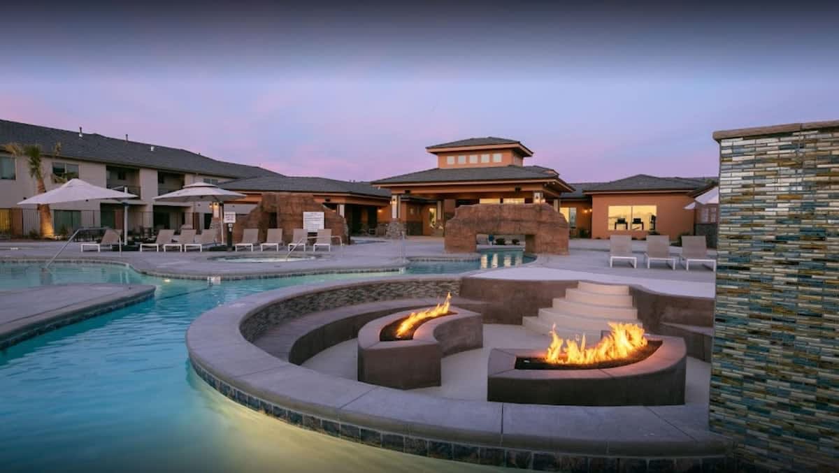 Community pool and fire pit lounge sunken into the pool