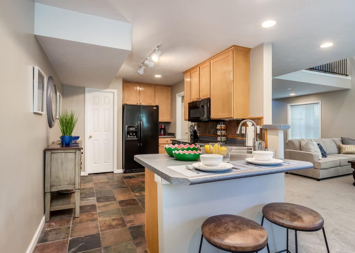 Full kitchen with bar seating in Union Gateway home