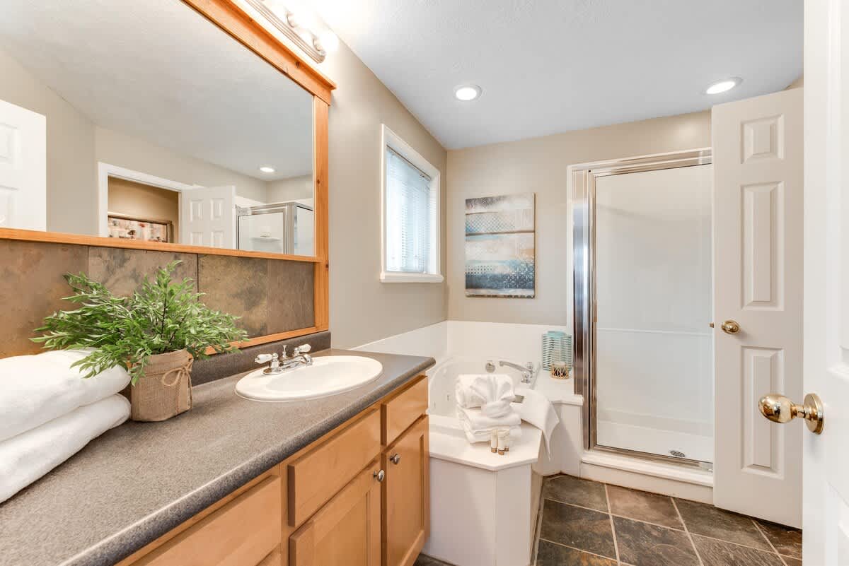 Master bathroom with tub and shower in Union Woods home